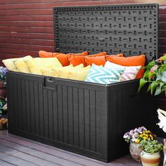 an outdoor storage box filled with lots of pillows