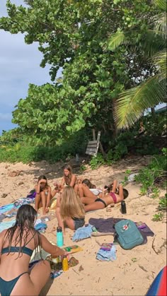 some people are sitting on the beach and having drinks