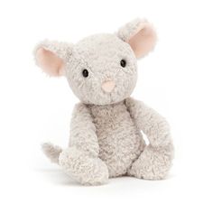 a white stuffed animal sitting up against a white background