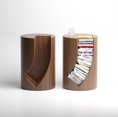 two wooden bookshelves with magazines in them on a white surface, one is open and the other is closed