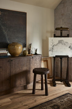 a chair and table in a room with a painting on the wall next to it