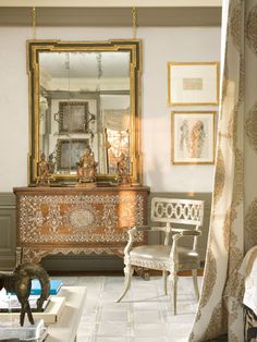 a living room filled with furniture and a mirror