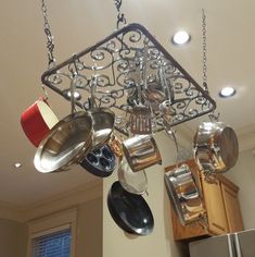 pots and pans are hanging from the ceiling