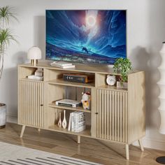 an entertainment center with a large television on it