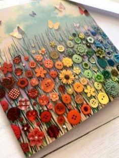 an open book with buttons on it and a pencil in front of the pages that have been altered to look like flowers