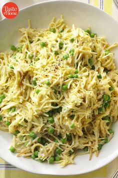 a white bowl filled with pasta and peas