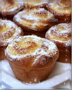 several pastries on a white plate covered in powdered sugar