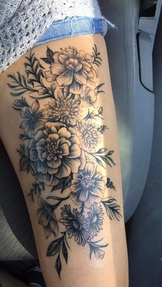 a woman's thigh with flowers on it