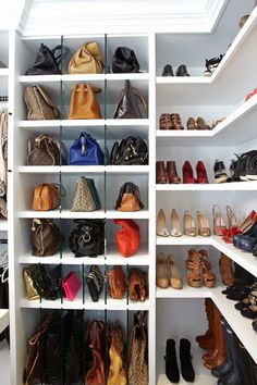 a closet filled with lots of different types of shoes and purses on shelving units