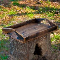 a wooden tray sitting on top of a tree stump