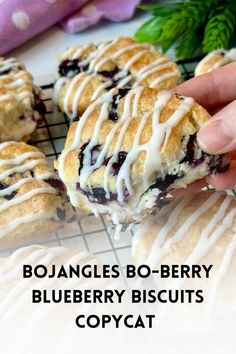 a hand holding a blueberry biscuit with white icing on it and the words boulanges b - berry blueberry biscuits copycat