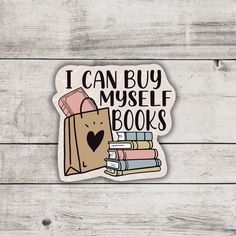 i can buy myself books sticker on a white wooden background with some books