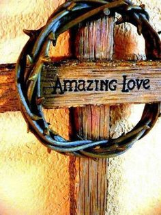 a wooden sign that says amazing love on it