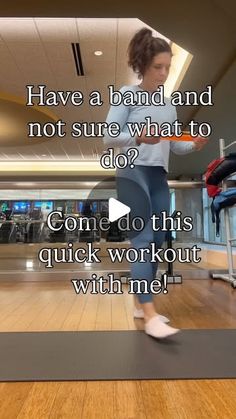 a woman standing on top of a wooden floor in front of a gym equipment rack