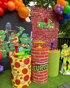 teenage mutant birthday party decorations including pizza boxes, balloons and decorating items on grass