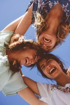 three young women are smiling and laughing together