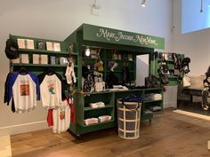 there are many items on display in the store, including shirts and t - shirts