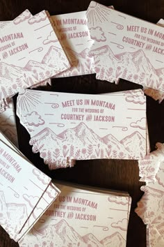 some pink and white candy bar wrappers sitting on top of a wooden table