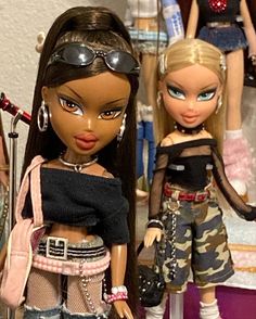 two dolls are standing next to each other