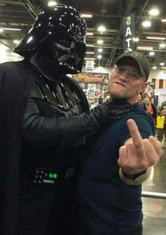 darth vader and luke star wars cosplaying at an expo convention