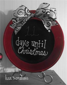 a black and red plate with a white bow on it that says 11 days until christmas