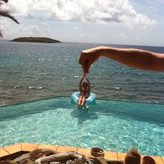 a person is standing in the water with their hand up