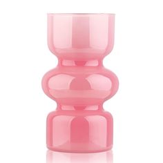 a pink vase sitting on top of a white table