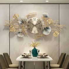 a dining room table with chairs and a large clock on the wall above it,