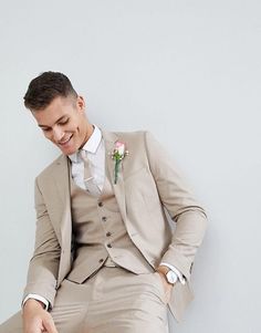 a man in a suit sitting on a chair