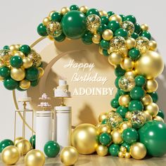 a birthday cake surrounded by balloons and confetti on a wooden table with a happy birthday sign in the background