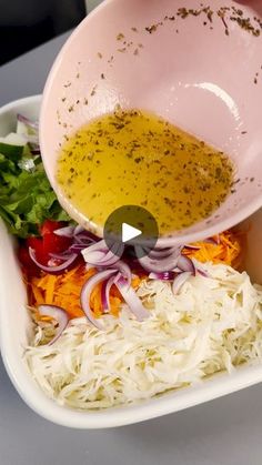 someone is pouring dressing into a bowl with onions, carrots and celery