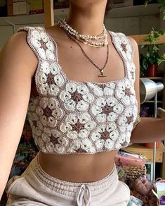 a woman wearing a crochet top and shorts