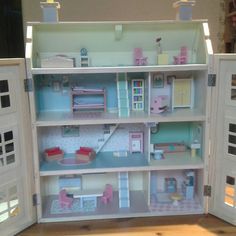 a doll house with all the furniture and accessories in it's open door display case