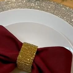 a white plate topped with a red bow tie