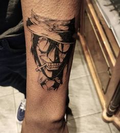 a man's leg with a tattoo on it that has a skull wearing a hat