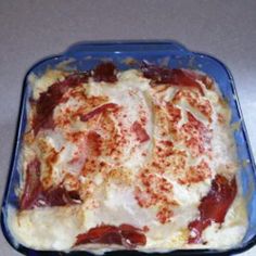 a casserole dish with meat and cheese in it