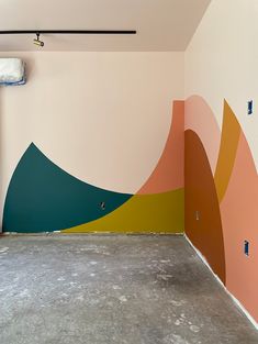 an empty room painted with different colors and shapes