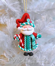 a christmas ornament hanging from a tree with candy canes and santa claus