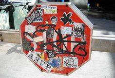 a stop sign covered in graffiti and stickers