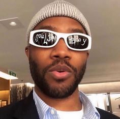 a man wearing sunglasses and a hat with the words happy birthday written on his glasses