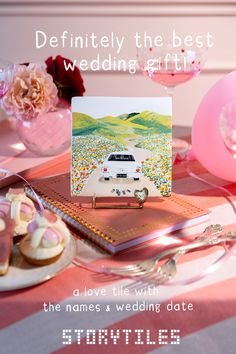 a table topped with pink and white plates filled with cake next to a card on top of a binder