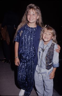 two young children standing next to each other