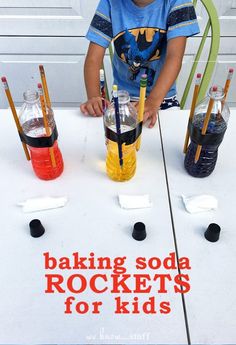 a little boy sitting at a table with some drinks