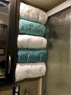 towels are stacked on top of each other in a bathroom