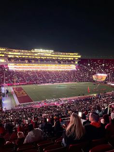 a stadium filled with lots of people at night