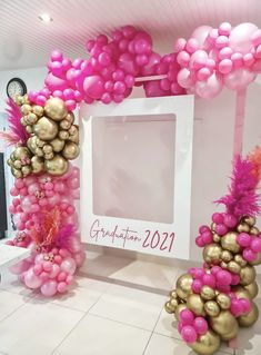 pink and gold balloons are in front of a photo frame with the word congratulations on it