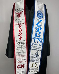 a white and blue graduation stole hanging on a black mannequin