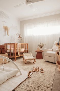 a baby's room with a crib, rocking chair and other items on the floor