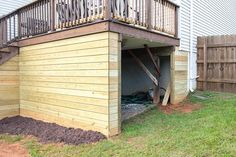 the back side of a house with a wooden deck