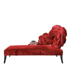 a cat laying on top of a red couch covered in fur and flowers with a white background